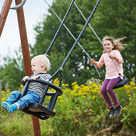 Children playing on playground swings